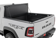 Load image into Gallery viewer, Rough Country Hard Tri-Fold Flip-Up Bed Cover Ram 1500 (19-26) / 1500 TRX (21-24)